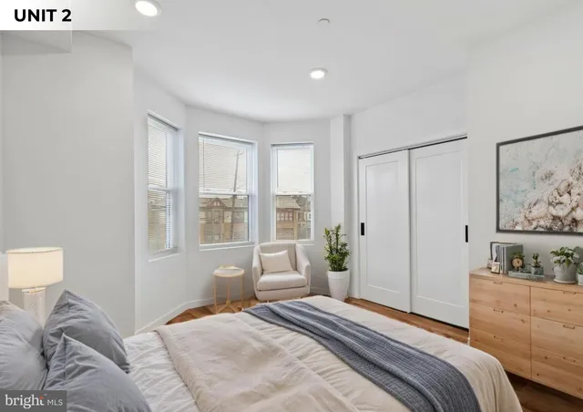 a bedroom with a large bed and a window