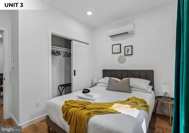 a bedroom with a bed and a mirror