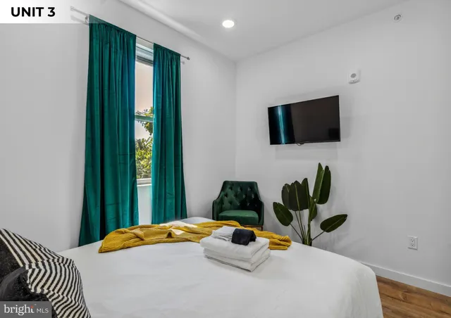 a bedroom with a bed and a flat screen tv