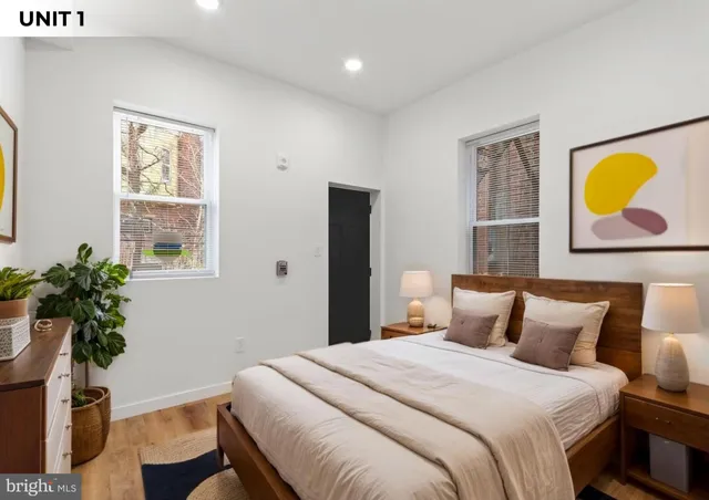 a bedroom with a bed and a potted plant