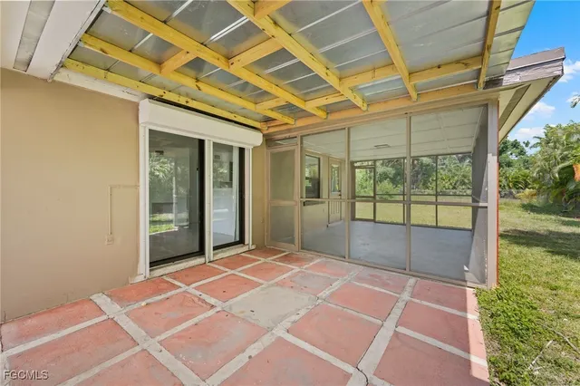 a view of a room with wooden floor and windows