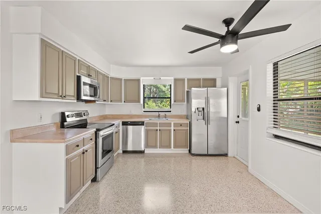 a kitchen with a stove a refrigerator and a sink