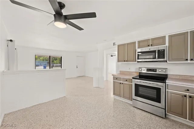 a kitchen with stainless steel appliances granite countertop a stove and a microwave