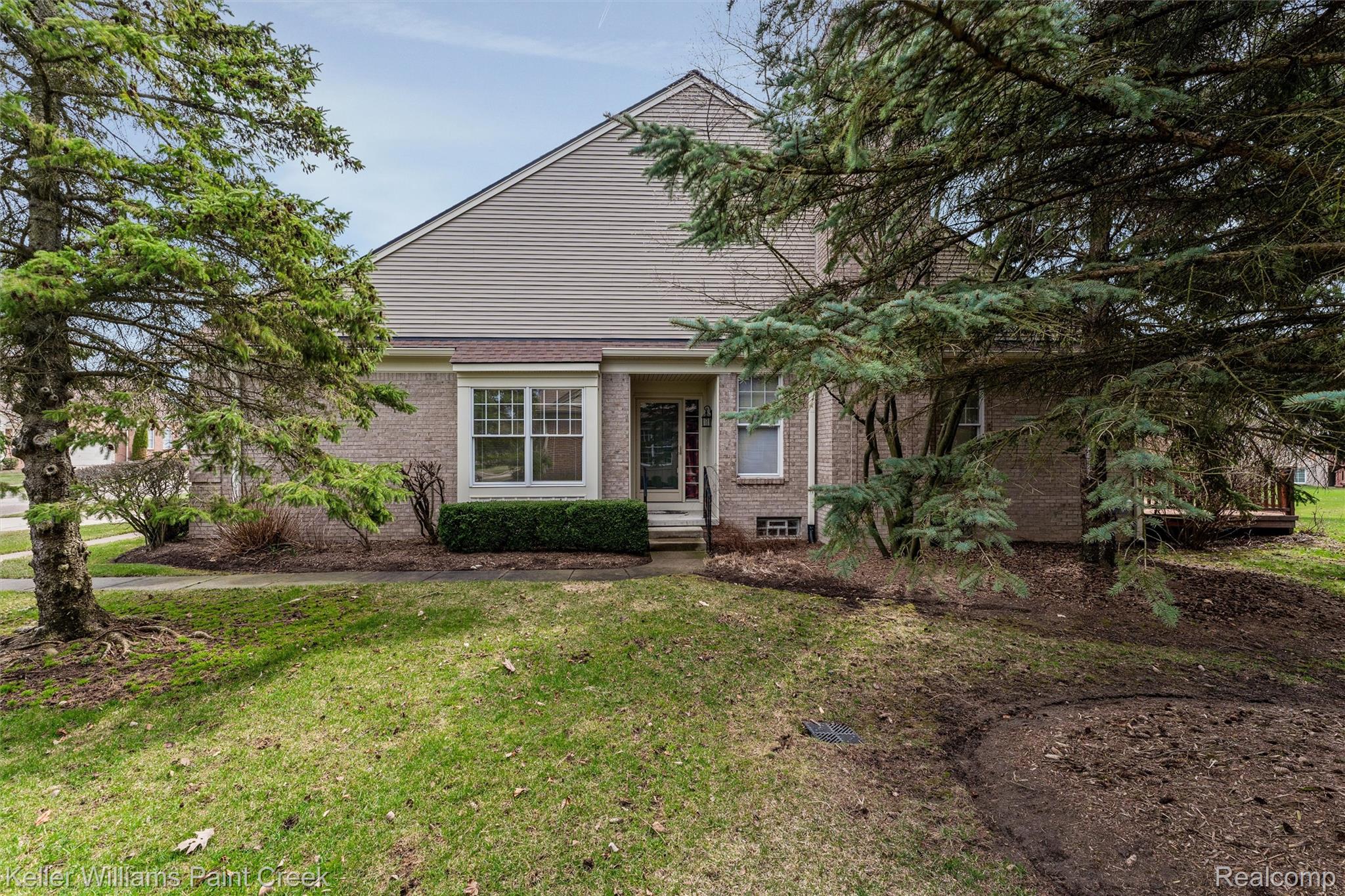 1685 Maple Creek Court Rochester, MI 48306 - Photo 41 of 49 View of front facade with brick siding and a front lawn