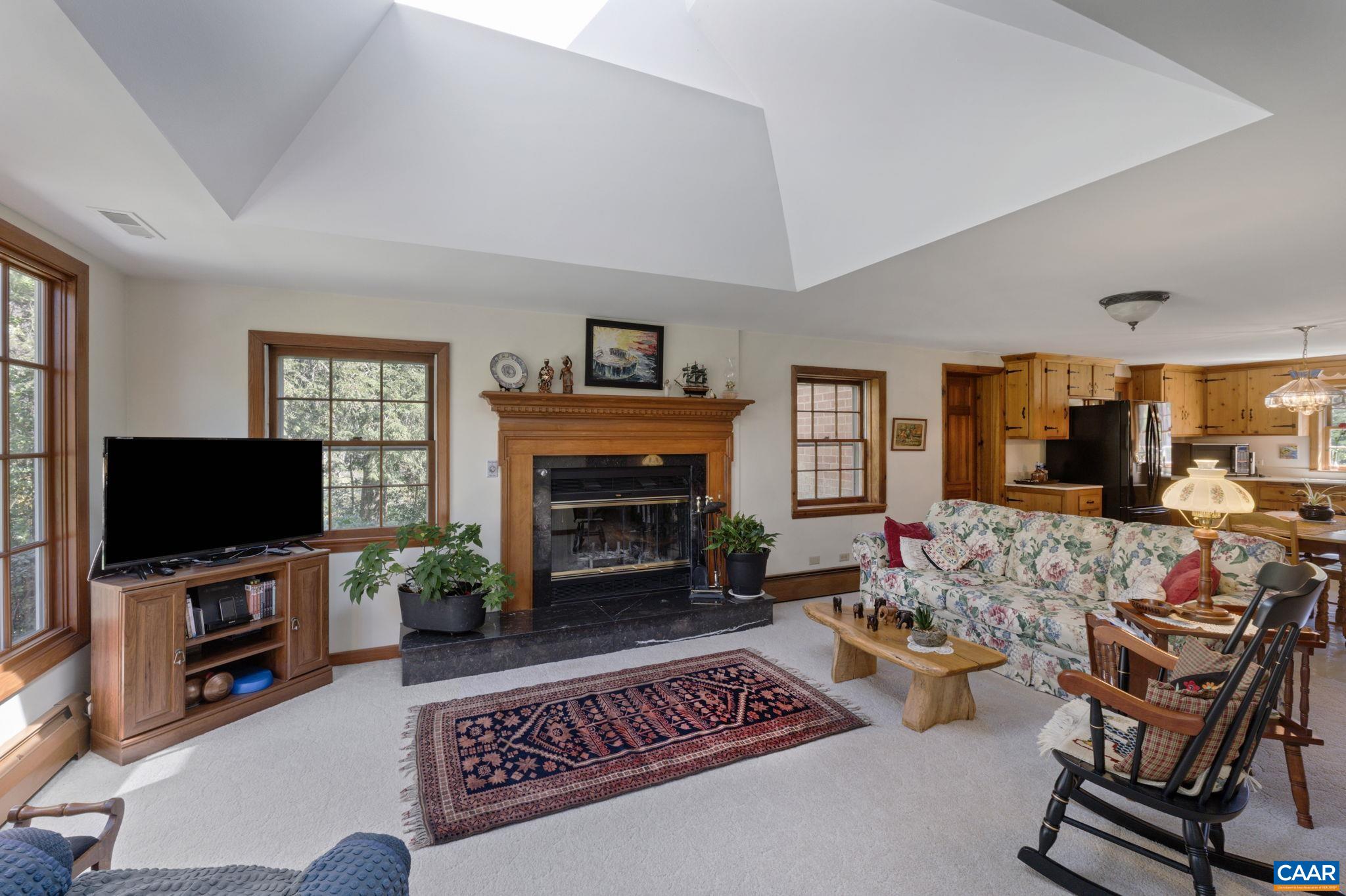 2507 Northfield Road Charlottesville, VA 22901 - Photo 19 of 68 a living room with furniture a flat screen tv and a fireplace