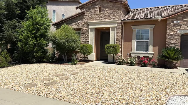 a view of a house with potted plants