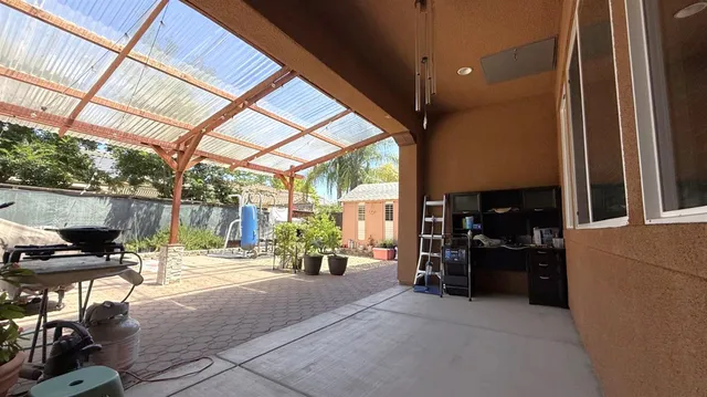 a view of a porch with furniture and a yard