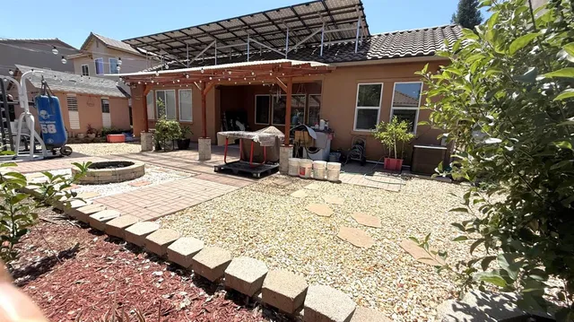a building outdoor space with patio furniture and potted plants