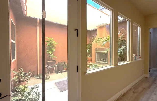 a view of a glass door and a yard from a window