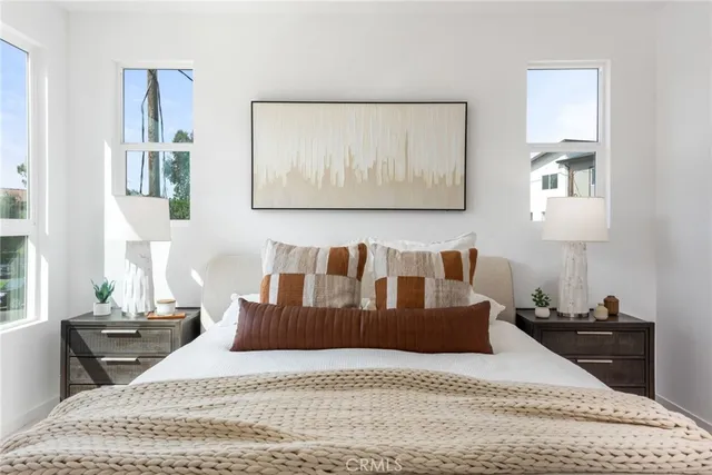 a large bedroom with a bed and wooden floor