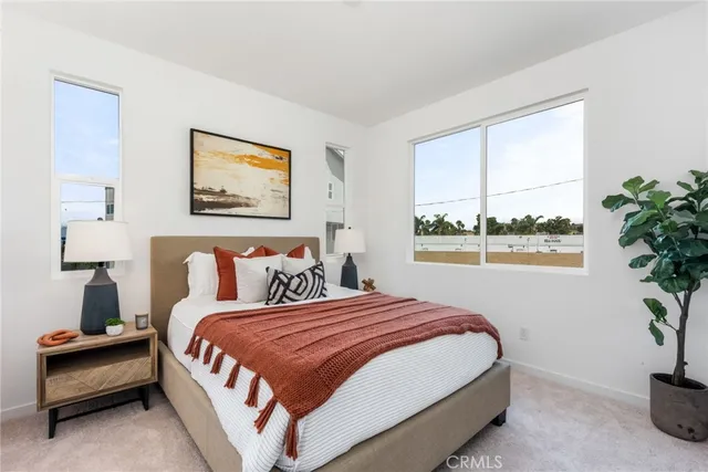 a bedroom with bed and a potted plant