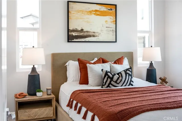 a bedroom with a bed and painting on the wall