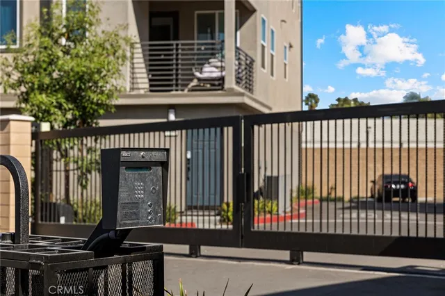 a view of a brick house with a small deck