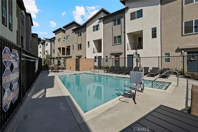 a view of a swimming pool with outdoor seating