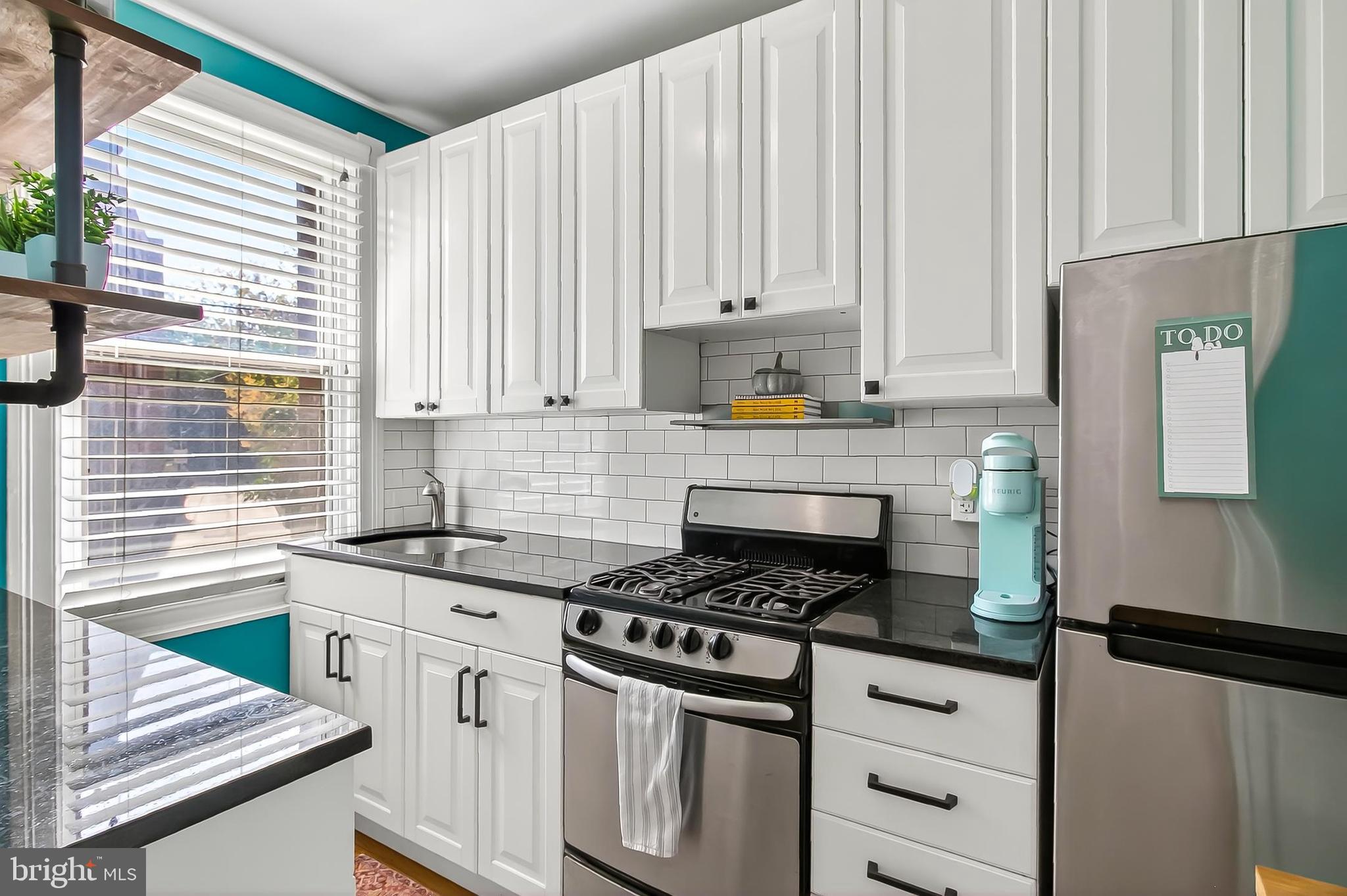 3600 Connecticut Avenue Northwest, Unit 105 Washington, DC 20008 - Photo 18 of 55 a kitchen with granite countertop white cabinets and white appliances