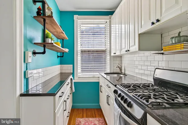 a kitchen with stainless steel appliances granite countertop a stove and a refrigerator