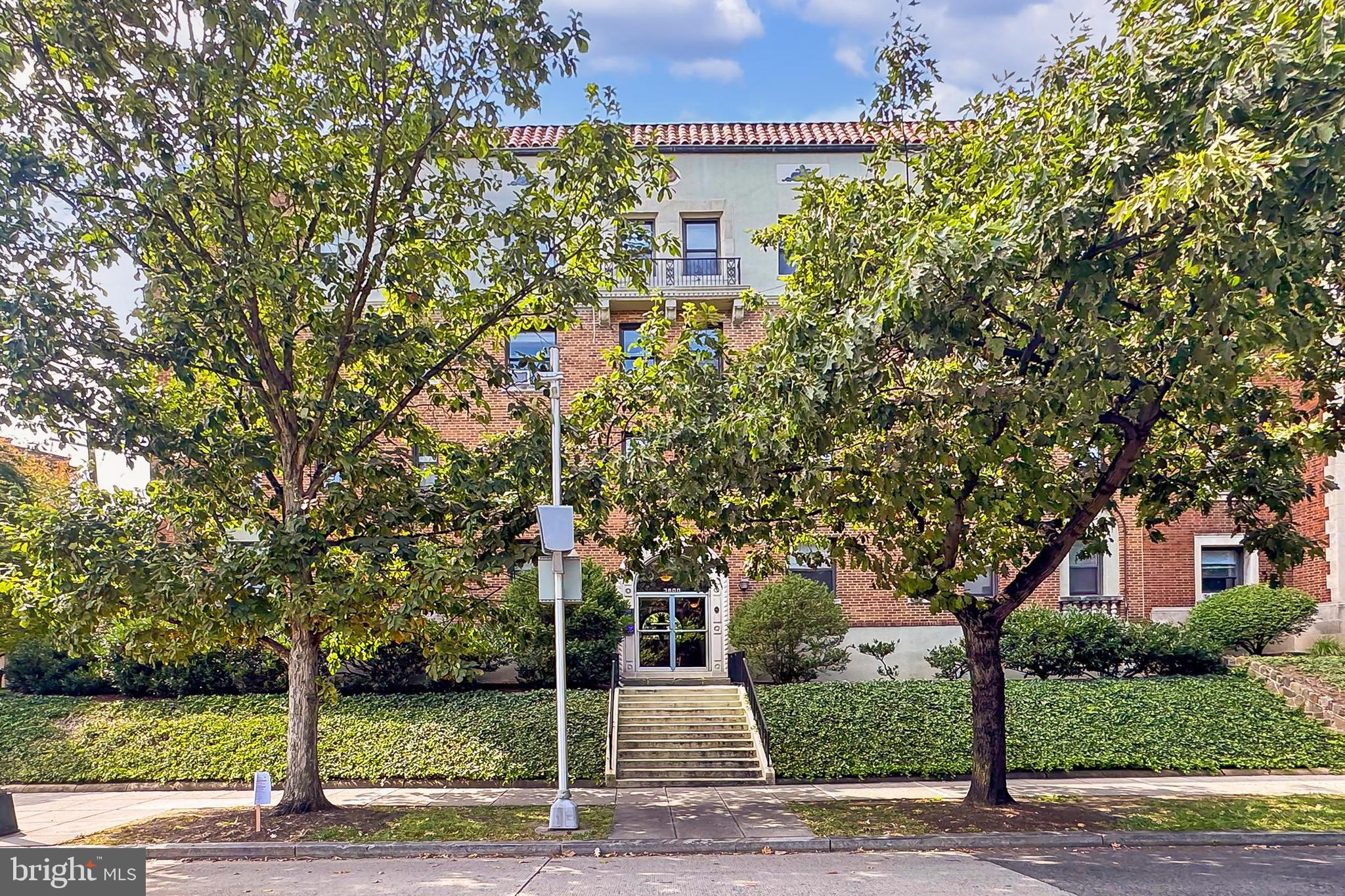 3600 Connecticut Avenue Northwest, Unit 105 Washington, DC 20008 - Photo 2 of 55 a view of a yard in front of a house with plants and large trees