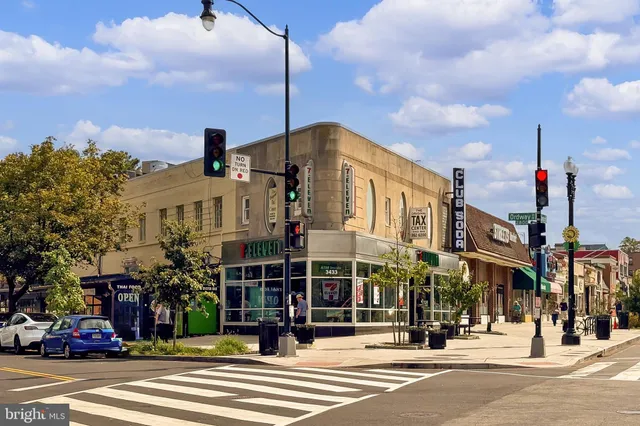 a view of a cafe with a table and chairs under an umbrella