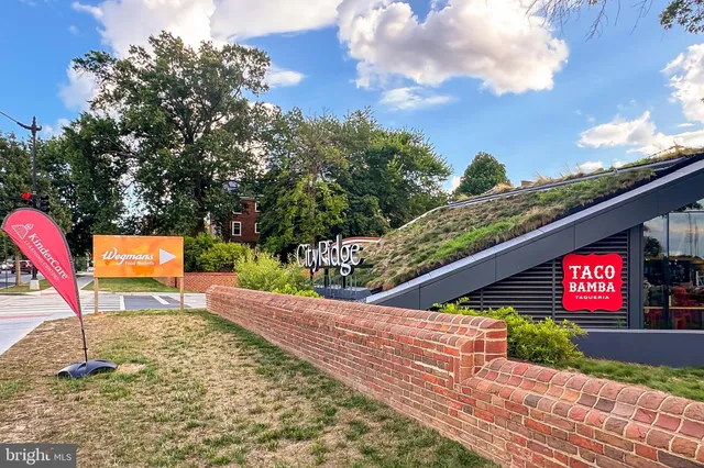 a row of table and chairs in front of building