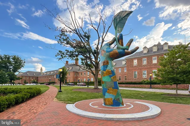 a view of a street with potted plants