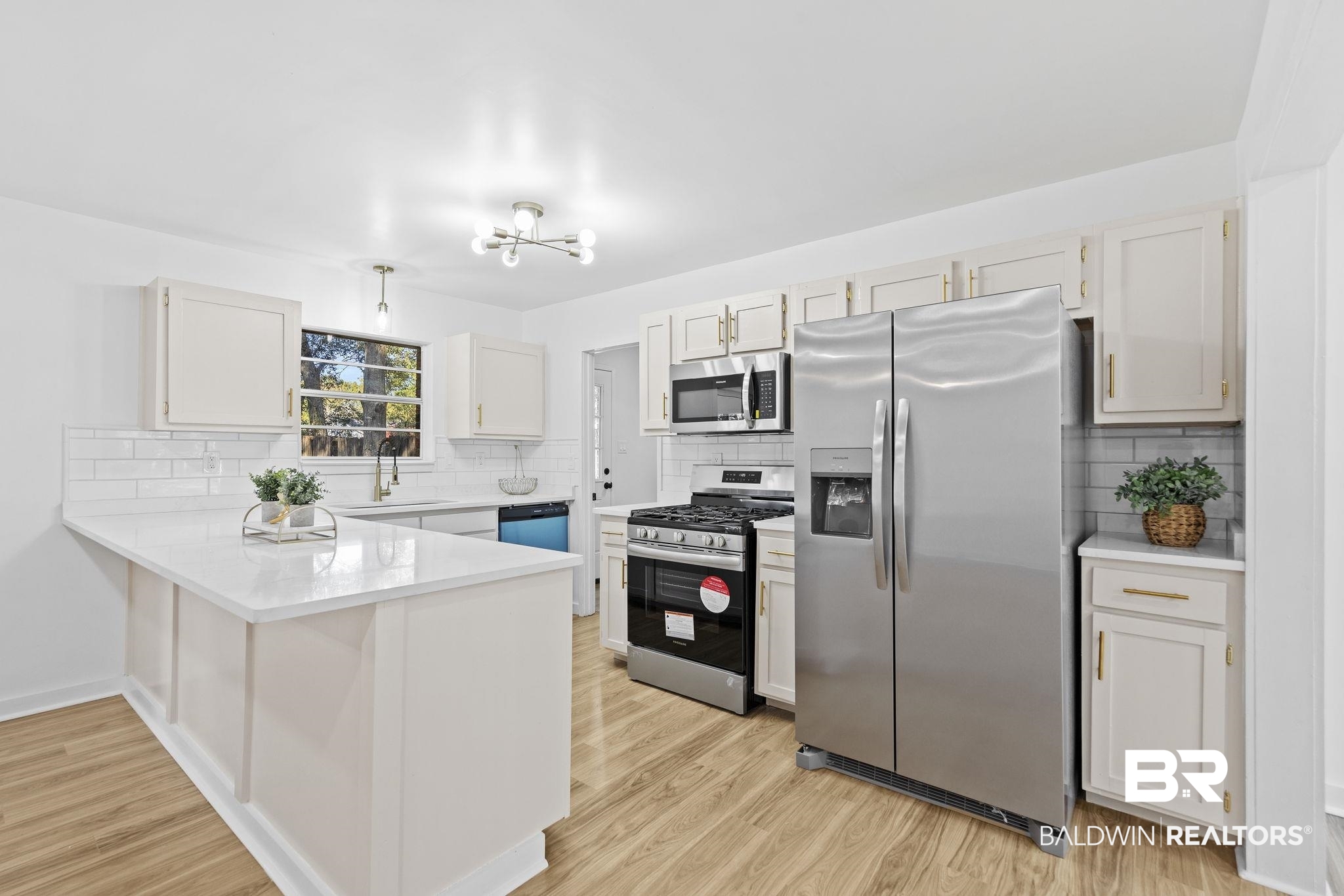 5398 Quail Run North Theodore, AL 36582 - Photo 7 of 46 Kitchen featuring white cabinets, appliances with stainless steel finishes, decorative backsplash, and sink