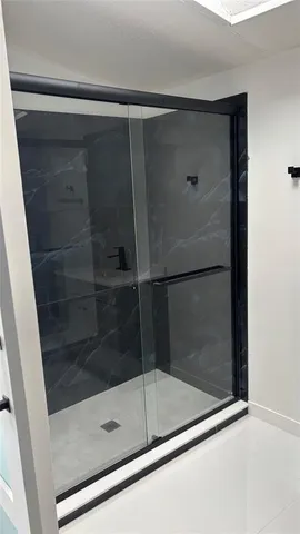 a bathroom with a glass shower door