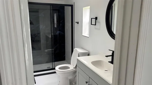 a bathroom with a toilet sink and shower