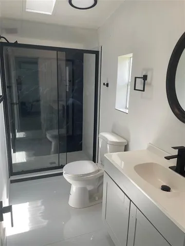 a bathroom with a sink toilet and shower