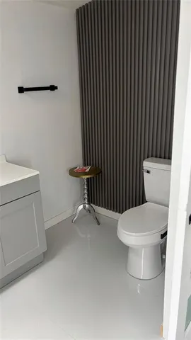 a white toilet sitting next to a bathroom sink