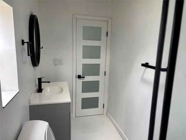 a bathroom with a sink toilet and vanity