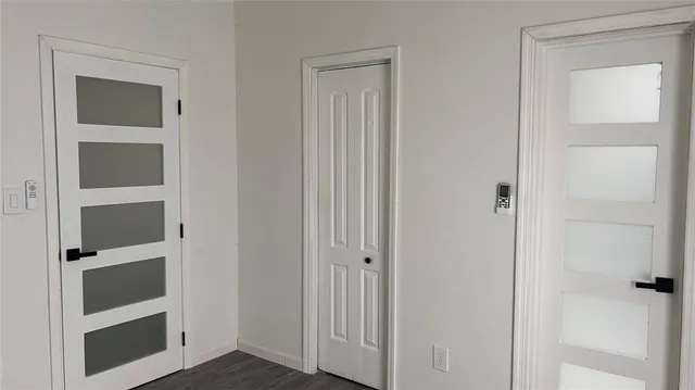 a view of walk in closet with empty racks