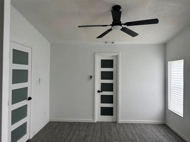 a view of a walk in closet and wooden floor