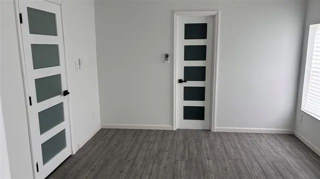 wooden floor in an empty room with a fireplace