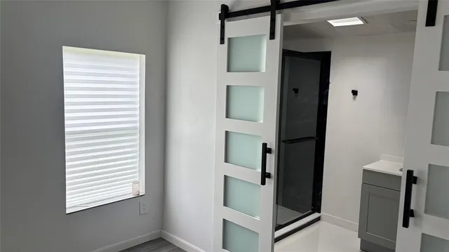 a bathroom with a shower and a sink