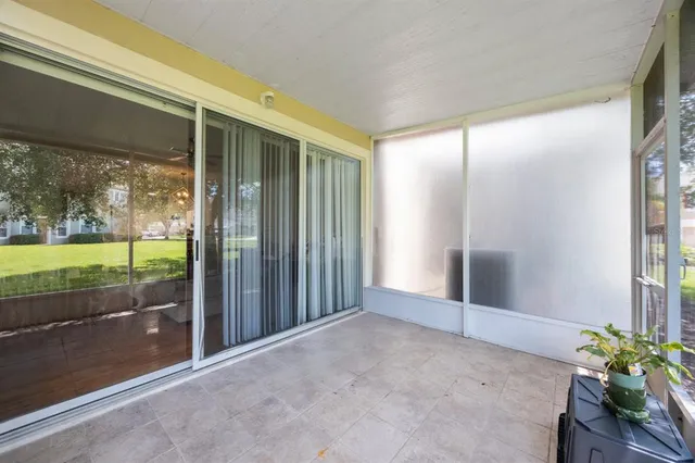 front view of a house with a yard and an tree