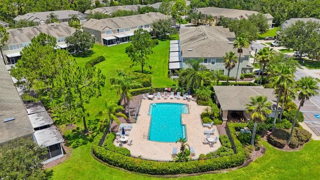 an aerial view of a house with a yard and lake view