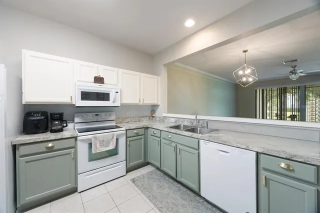 a kitchen with a sink cabinets and stainless steel appliances