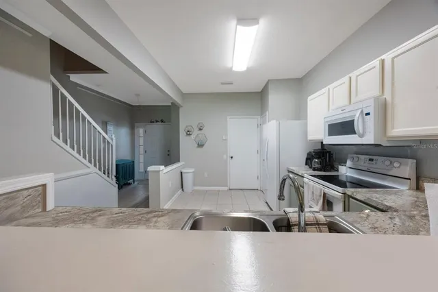a kitchen with a stove top oven and cabinets