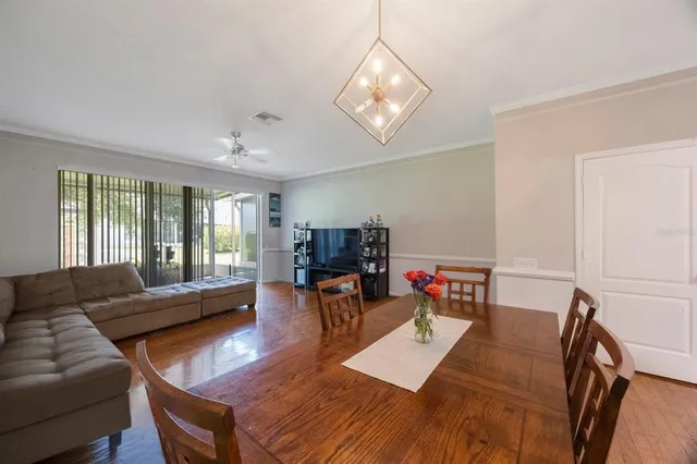 a view of a dining room with furniture and wooden floor