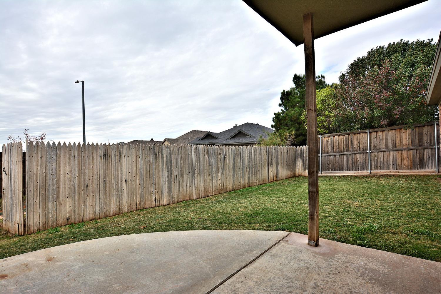 2623 112th Street Lubbock, TX 79423 - Photo 15 of 16 a view of a backyard with a fence
