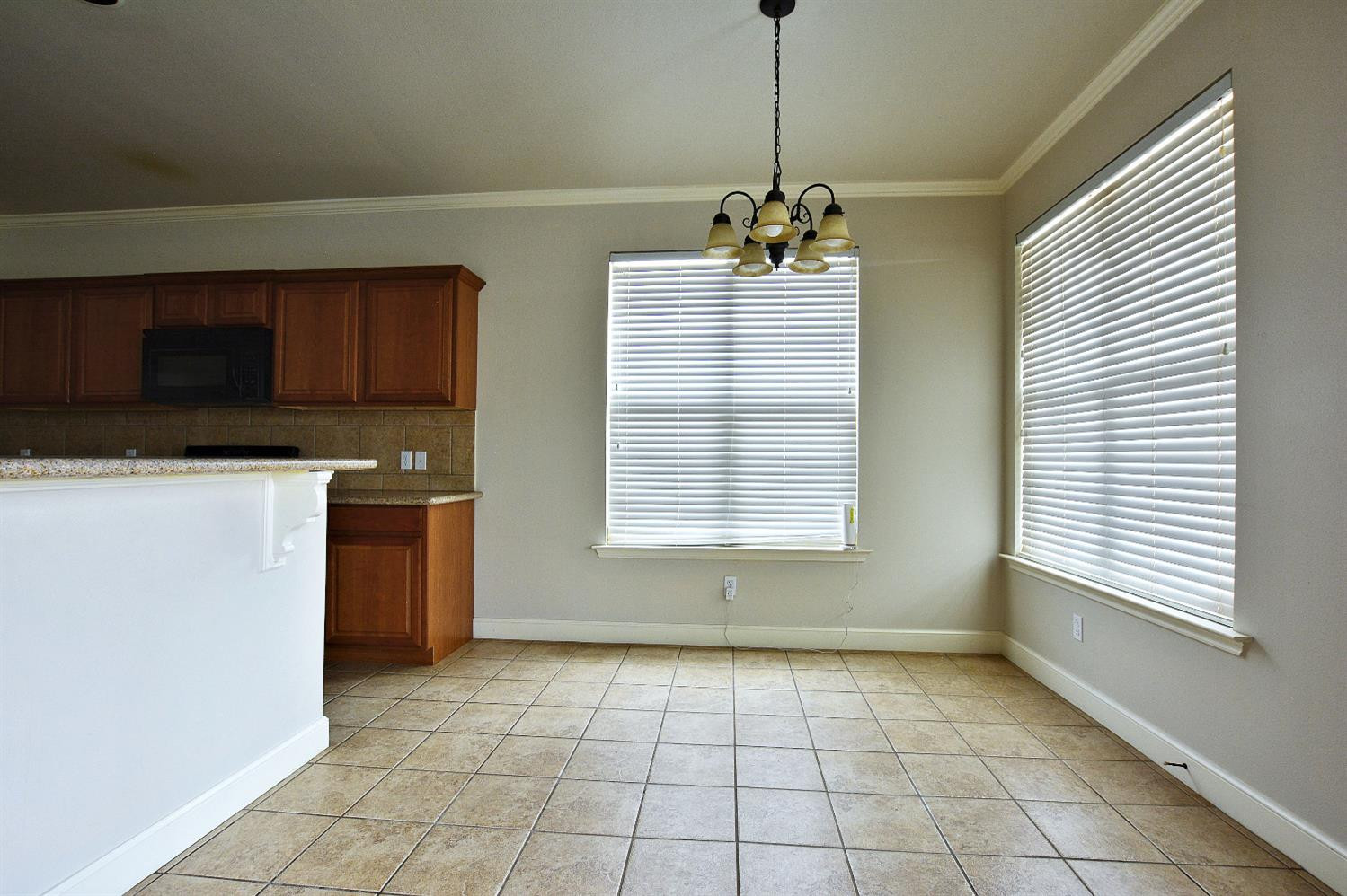 2623 112th Street Lubbock, TX 79423 - Photo 7 of 16 a view of a kitchen with a sink and dishwasher windows