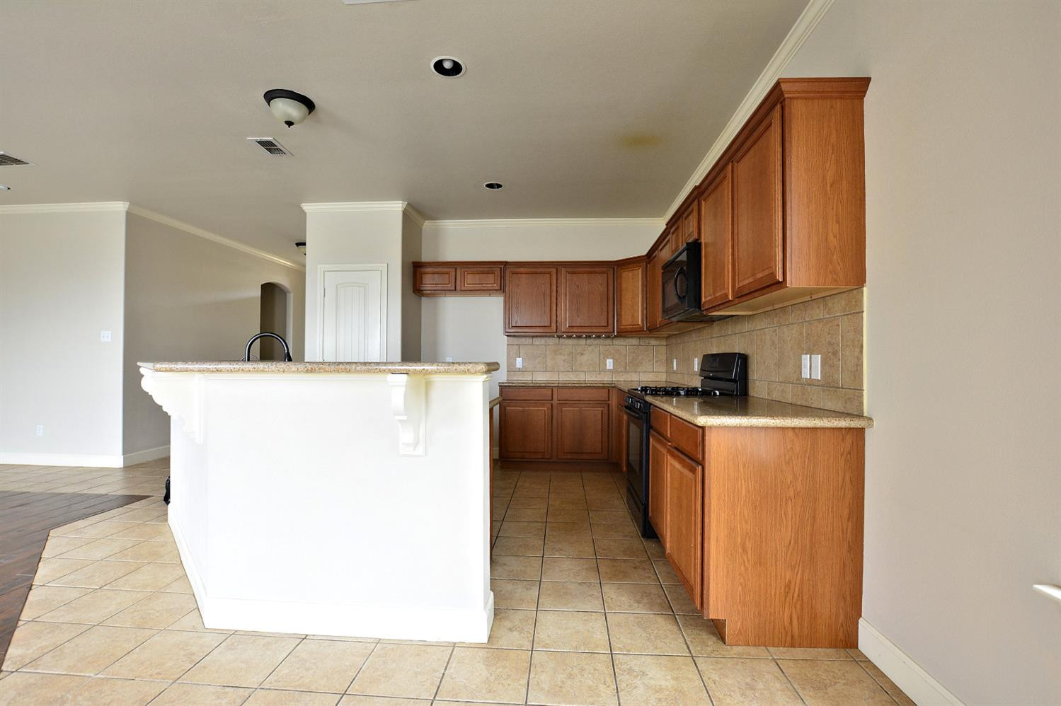 2623 112th Street Lubbock, TX 79423 - Photo 8 of 16 a kitchen with a sink a counter top space and cabinets
