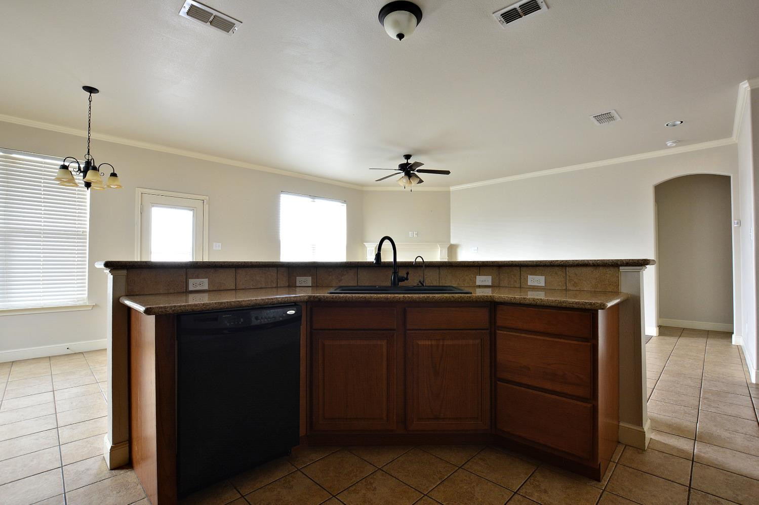 2623 112th Street Lubbock, TX 79423 - Photo 10 of 16 a kitchen with a sink and cabinets