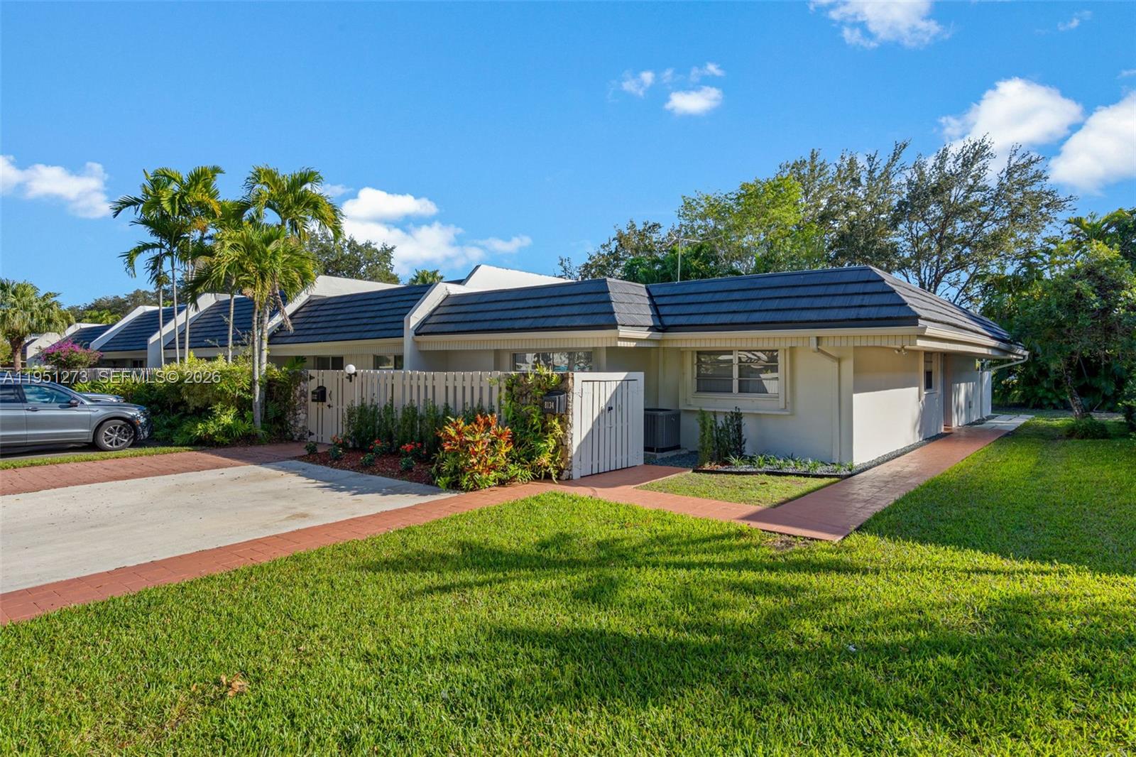 8134 Southwest 83rd Street Miami, FL 33143 - Photo 14 of 15 a front view of a house with a yard and porch