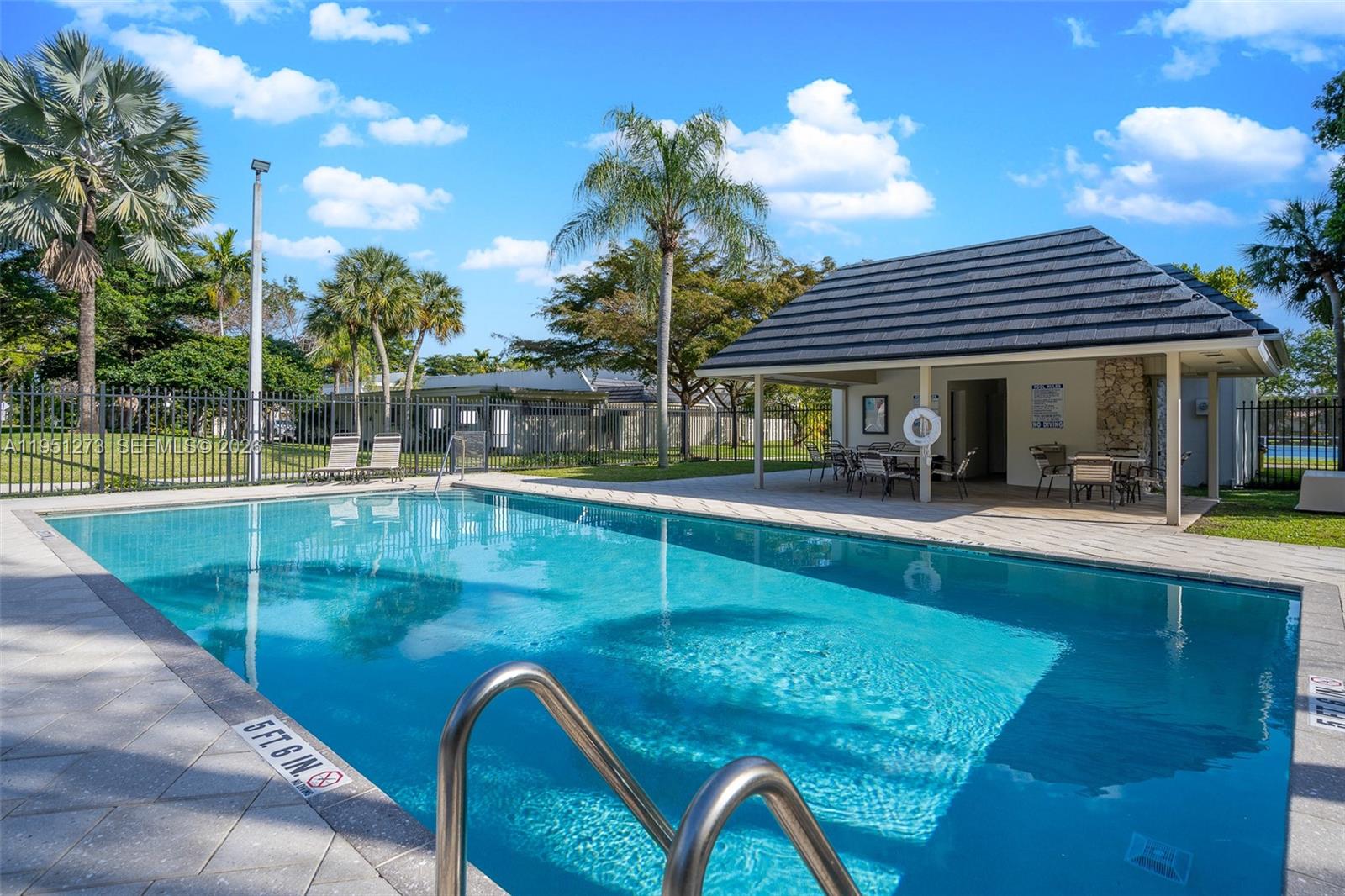 8134 Southwest 83rd Street Miami, FL 33143 - Photo 15 of 15 a view of a swimming pool with a patio