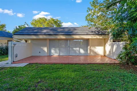 a view of a yard with plants and trees