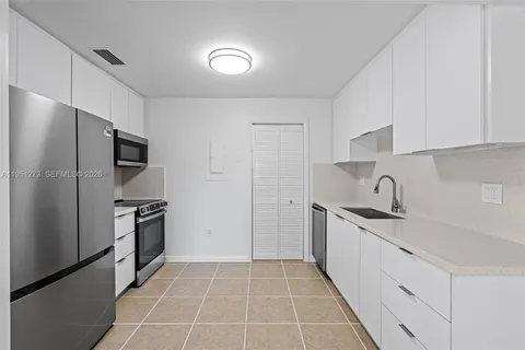 a kitchen with a sink microwave and refrigerator
