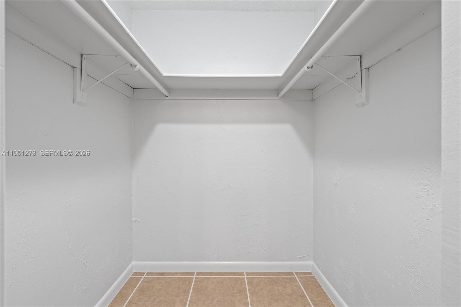 8134 Southwest 83rd Street Miami, FL 33143 - Photo 7 of 15 a view of walk in closet with empty racks