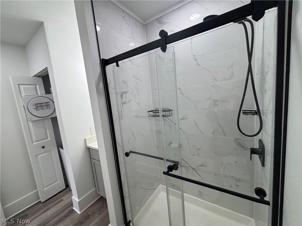 4115 Whitman Avenue, Unit UP Cleveland, OH 44113 - Photo 11 of 12 Full bath with a marble finish shower, vanity, and dark wood-type flooring