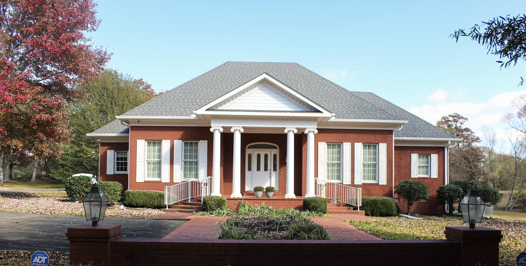a front view of a house with garden